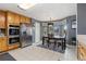 Well-equipped kitchen with stainless steel appliances, a bay window, and an adjacent dining area at 107 Prairie Falcon Pkwy, Brighton, CO 80601