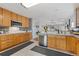 Spacious kitchen featuring wood cabinets, stainless steel appliances, and ample counter space at 107 Prairie Falcon Pkwy, Brighton, CO 80601