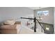 A loft space with a view of the lower level, a chandelier, and a comfortable chair at 107 Prairie Falcon Pkwy, Brighton, CO 80601