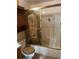 Bathroom with shower/tub combo and wood cabinet at 6500 W 14Th Ave, Lakewood, CO 80214