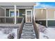 Two-story home with front porch and snow-covered walkway at 739 Widgeon Cir, Longmont, CO 80503