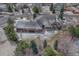 Aerial view of home showcasing expansive lawn, mature trees and lush landscaping with circular driveway at 14581 E Oberlin Pl, Aurora, CO 80014
