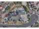 Overhead shot of a large brick home with an expansive roof and well-kept landscaping at 14581 E Oberlin Pl, Aurora, CO 80014