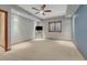 Empty basement area with ceiling fan, window, and tv mount at 14581 E Oberlin Pl, Aurora, CO 80014