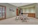 Basement with dining area, kitchenette, stainless steel fridge, and a glass door at 14581 E Oberlin Pl, Aurora, CO 80014