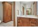 Bathroom featuring wood cabinets, white countertops, and tiled floors at 14581 E Oberlin Pl, Aurora, CO 80014