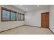 Sun-lit bedroom featuring carpeted floors and natural wood window and baseboard trim at 14581 E Oberlin Pl, Aurora, CO 80014