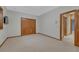 This cozy bedroom features neutral carpet, wood trim, and plenty of closet space at 14581 E Oberlin Pl, Aurora, CO 80014
