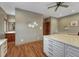 Bedroom featuring wooden floors, ceiling fan, large dresser, and bathroom access at 14581 E Oberlin Pl, Aurora, CO 80014