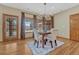 Bright dining room with hardwood floors, large windows, and a modern chandelier at 14581 E Oberlin Pl, Aurora, CO 80014