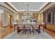 Formal dining room with a chandelier, hardwood floors, and a window with elegant drapes at 14581 E Oberlin Pl, Aurora, CO 80014