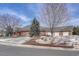 A sprawling brick home with a four-car garage, large front yard, and mature trees at 14581 E Oberlin Pl, Aurora, CO 80014