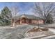 Charming brick home featuring a stone pathway, mature trees, and a classic front facade at 14581 E Oberlin Pl, Aurora, CO 80014