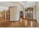 Elegant foyer with gleaming hardwood floors, arched doorways, and a stunning wood front door with glass accents at 14581 E Oberlin Pl, Aurora, CO 80014