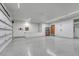 Garage with a white epoxy floor and a partition separating the garage and house at 14581 E Oberlin Pl, Aurora, CO 80014