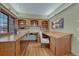 Well-lit home office with custom built-in shelving, desk and hardwood floors at 14581 E Oberlin Pl, Aurora, CO 80014