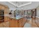 Gourmet kitchen with a large island, granite countertops, custom cabinets, and stainless steel appliances at 14581 E Oberlin Pl, Aurora, CO 80014