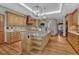Spacious kitchen boasts wood cabinets, granite countertops, tile backsplash, and pendant lighting at 14581 E Oberlin Pl, Aurora, CO 80014