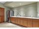 Kitchenette with stainless steel fridge, sink, counter, and wood cabinets at 14581 E Oberlin Pl, Aurora, CO 80014