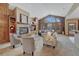 Bright living room featuring a fireplace, built-in cabinets, and a large window overlooking the backyard at 14581 E Oberlin Pl, Aurora, CO 80014