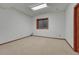 This spare room features neutral carpet, wood trim, and a large window at 14581 E Oberlin Pl, Aurora, CO 80014
