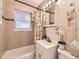 Bathroom with shower-tub combo, vanity sink, and stylish tile work at 3440 N Steele St, Denver, CO 80205