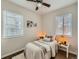 Bedroom featuring twin beds, hardwood floors, and dual windows for natural light and comfort at 3440 N Steele St, Denver, CO 80205