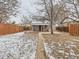 Charming home exterior with covered porch and walkway leading to the front door surrounded by the fenced yard at 3440 N Steele St, Denver, CO 80205