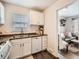 Functional kitchen with white cabinets, gas range, and stainless steel sink, with a bright and airy feel at 3440 N Steele St, Denver, CO 80205