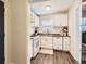 Functional kitchen with white cabinets, gas range, and stainless steel sink, offering a practical cooking space at 3440 N Steele St, Denver, CO 80205