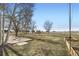 Expansive backyard featuring a play structure, patio, and white fencing, creating a fun and safe outdoor space at 16021 Verbena St, Brighton, CO 80602