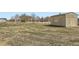 Vast backyard with a shed, play structure, and fencing, providing ample space for outdoor activities at 16021 Verbena St, Brighton, CO 80602