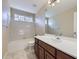 Bathroom featuring a vanity with sink, and a tiled tub and shower combination at 16021 Verbena St, Brighton, CO 80602