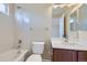 Bathroom featuring a tiled tub and shower combination, with vanity and sink at 16021 Verbena St, Brighton, CO 80602