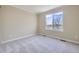 Bedroom featuring neutral walls, plush carpet, and a window with neighborhood views at 16021 Verbena St, Brighton, CO 80602