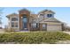 Charming two-story home featuring a brick facade, arched entryway, and well-maintained landscaping at 16021 Verbena St, Brighton, CO 80602