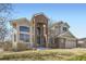 Charming two-story home with a brick facade, arched entryway, and well-manicured lawn at 16021 Verbena St, Brighton, CO 80602