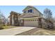 Two-story home showcasing brick accents, an attached two-car garage, and a concrete driveway at 16021 Verbena St, Brighton, CO 80602