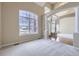 Bright living room featuring soaring ceilings, large windows, and neutral carpet at 16021 Verbena St, Brighton, CO 80602