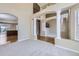 Inviting living space showcasing columns, hardwood floors, a staircase, and views into the kitchen at 16021 Verbena St, Brighton, CO 80602