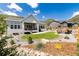 Spacious backyard featuring a well-maintained lawn, fire pit area, and mountain views at 5225 Mesa Top Dr, Monument, CO 80132