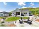 Landscaped backyard with a patio, fire pit, lush lawn, and scenic mountain views at 5225 Mesa Top Dr, Monument, CO 80132