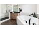 Modern bathroom boasts a soaking tub, glass-enclosed shower, and a stylish vanity with sink at 5225 Mesa Top Dr, Monument, CO 80132