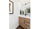 Stylish half bathroom with modern fixtures, a decorative mirror, and a sleek design at 5225 Mesa Top Dr, Monument, CO 80132