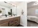 Modern bathroom with double sinks, quartz countertops, and stylish wood cabinets at 5225 Mesa Top Dr, Monument, CO 80132