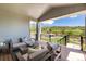 Relaxing covered patio with comfortable seating, offering picturesque views of the surrounding landscape at 5225 Mesa Top Dr, Monument, CO 80132