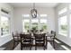 Bright dining room with modern chandelier, large windows showcasing scenic outdoor views, and hardwood floors at 5225 Mesa Top Dr, Monument, CO 80132