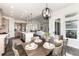 Open concept dining room and kitchen area features hardwood floors, island, and pendant lighting at 5225 Mesa Top Dr, Monument, CO 80132