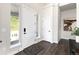 Bright entryway featuring hardwood floors, white trim, and a stylish front door, creating a welcoming first impression at 5225 Mesa Top Dr, Monument, CO 80132