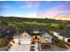 Stunning craftsman home featuring a 3-car garage, welcoming front porch, and professional landscaping against a beautiful sunset at 5225 Mesa Top Dr, Monument, CO 80132